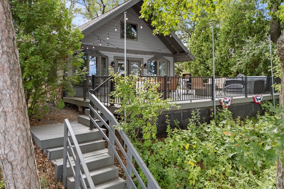 The fenced-in deck includes a gate that opens directly to the stairs for easy lake access