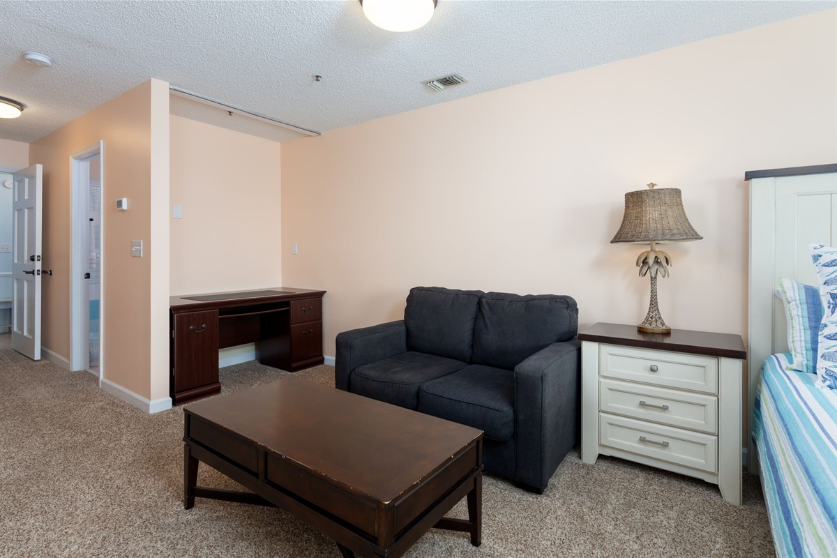 Bedroom 1 includes a cozy seating area