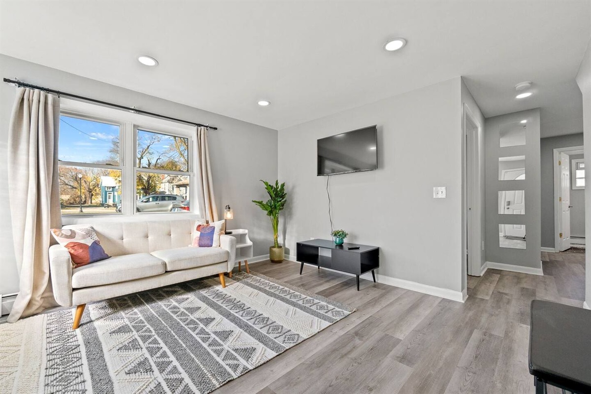 Beautiful living room featuring a comfortable couch and a window that offers a peaceful, scenic view.