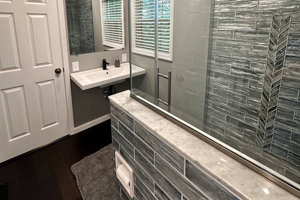 Side View: Bathroom Shower & Sink with Vanity Mirror