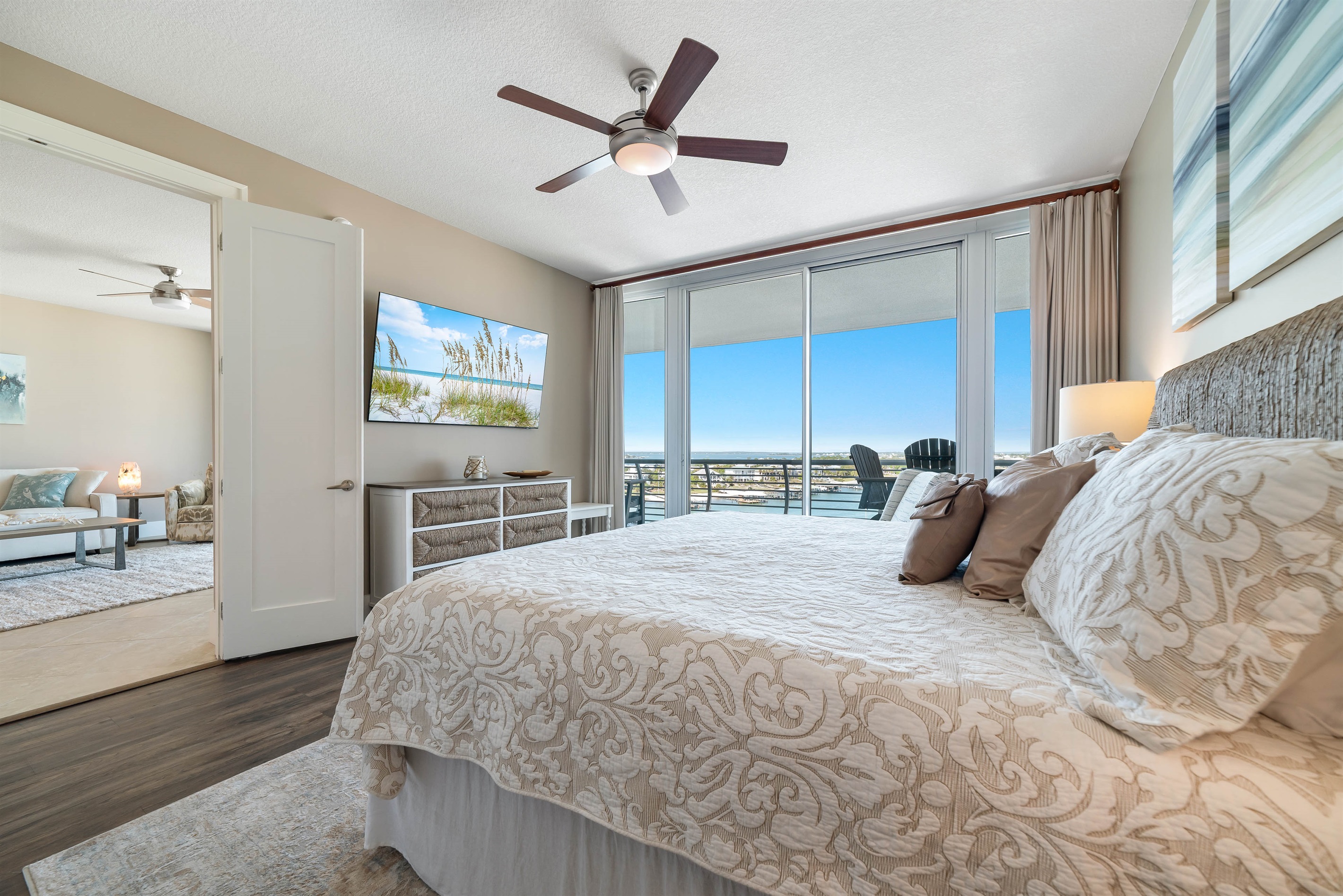 This thoughtfully designed Primary bedroom with king-size bed maximizes natural light and integrates seamlessly with the surrounding environment. The expansive sliding doors and serene color palette create a harmonious and inviting space.