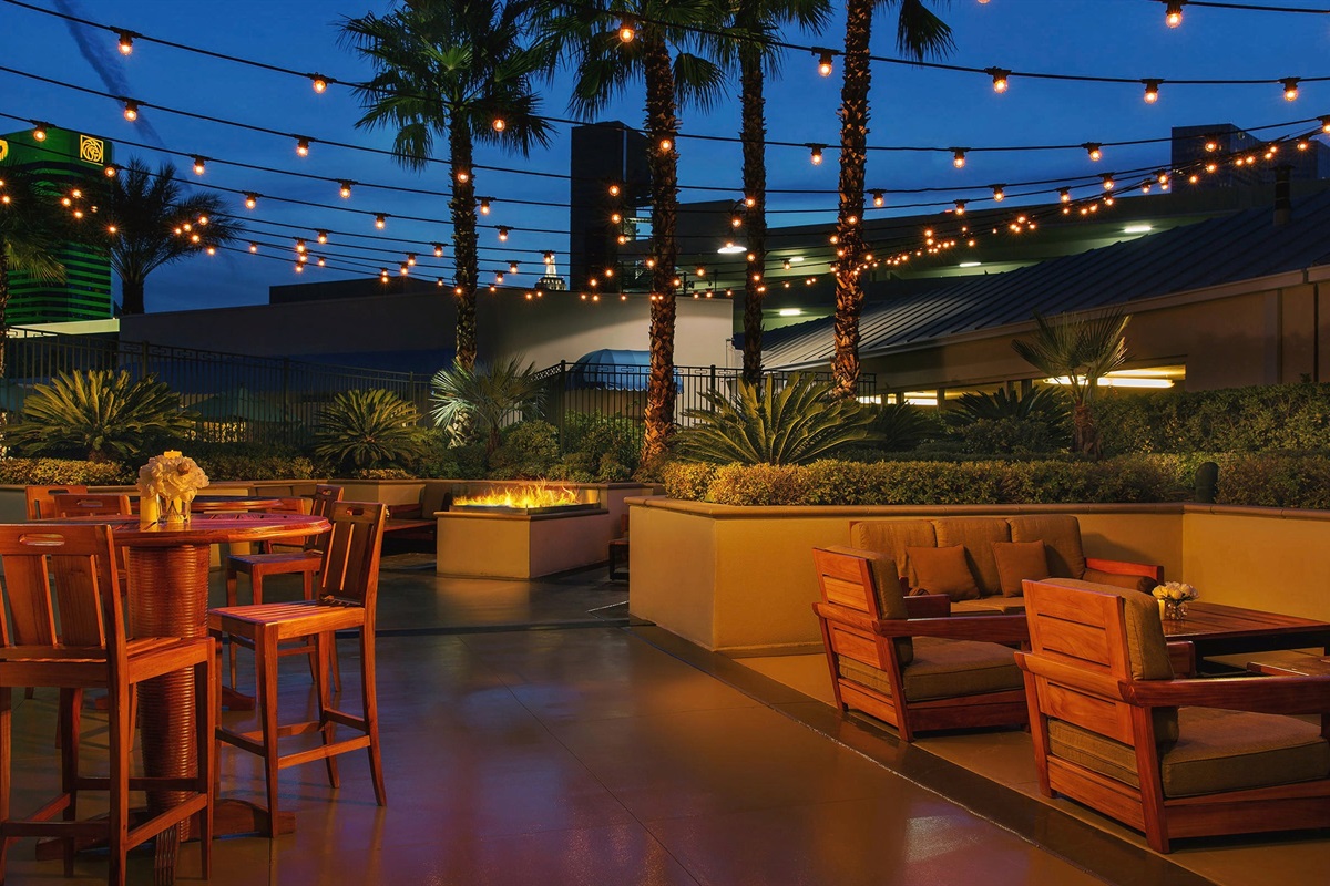 Relax under the Vegas stars with cozy outdoor seating and glowing string lights. ✨🌴