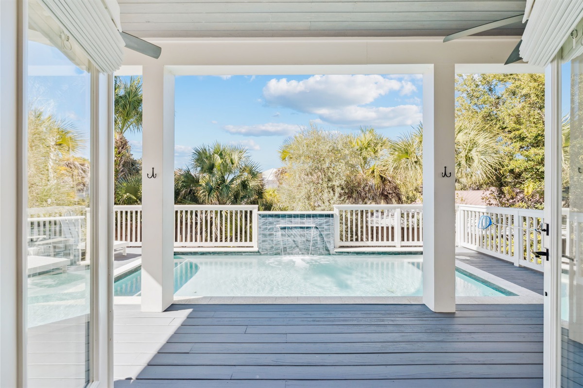 Private outdoor pool area conveniently located just outside the living room and kitchen, featuring a heated pool with a beautiful waterfall, seating and loungers, plus an outdoor grill and kitchenette