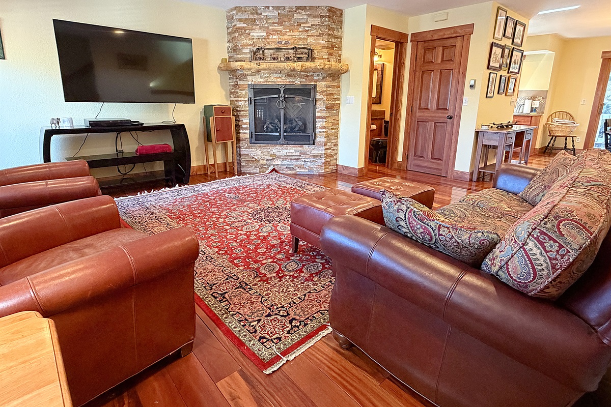Spacious living room with large TV and gas fireplace