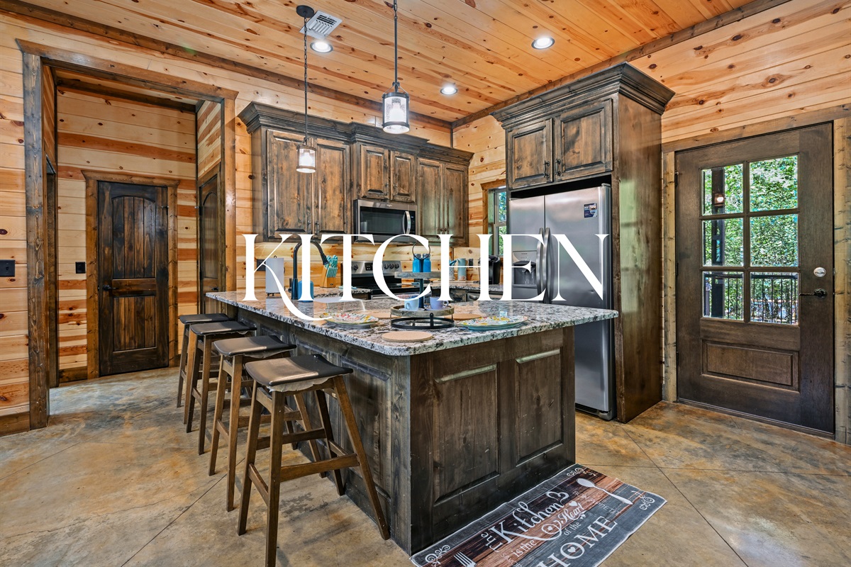 This modern-rustic kitchen has everything you need to prepare meals, with granite counters, a central island, and a spacious layout.