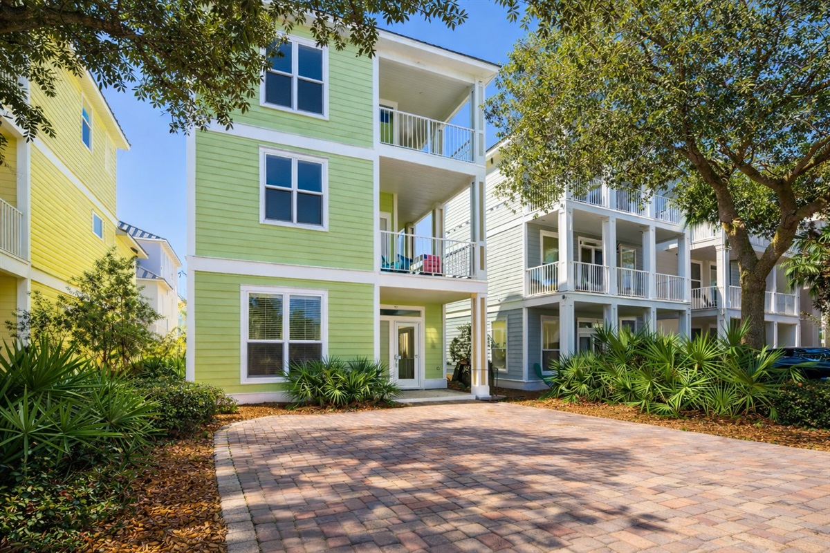 Seas The Dream - your pastel green and peach-colored getaway! Parking for THREE cars in the driveway