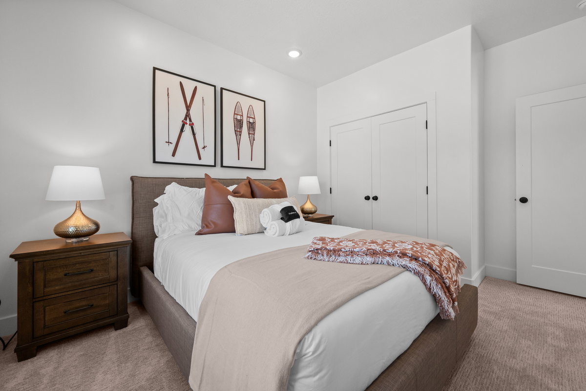 Thoughtful furnishings and cozy bedding make this bedroom feel welcoming and relaxed.