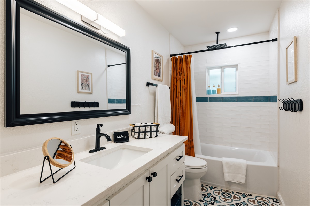 guest bathroom is right between bedroom 2 and 3, has full rain shower and bath tub, fully stocked with towels