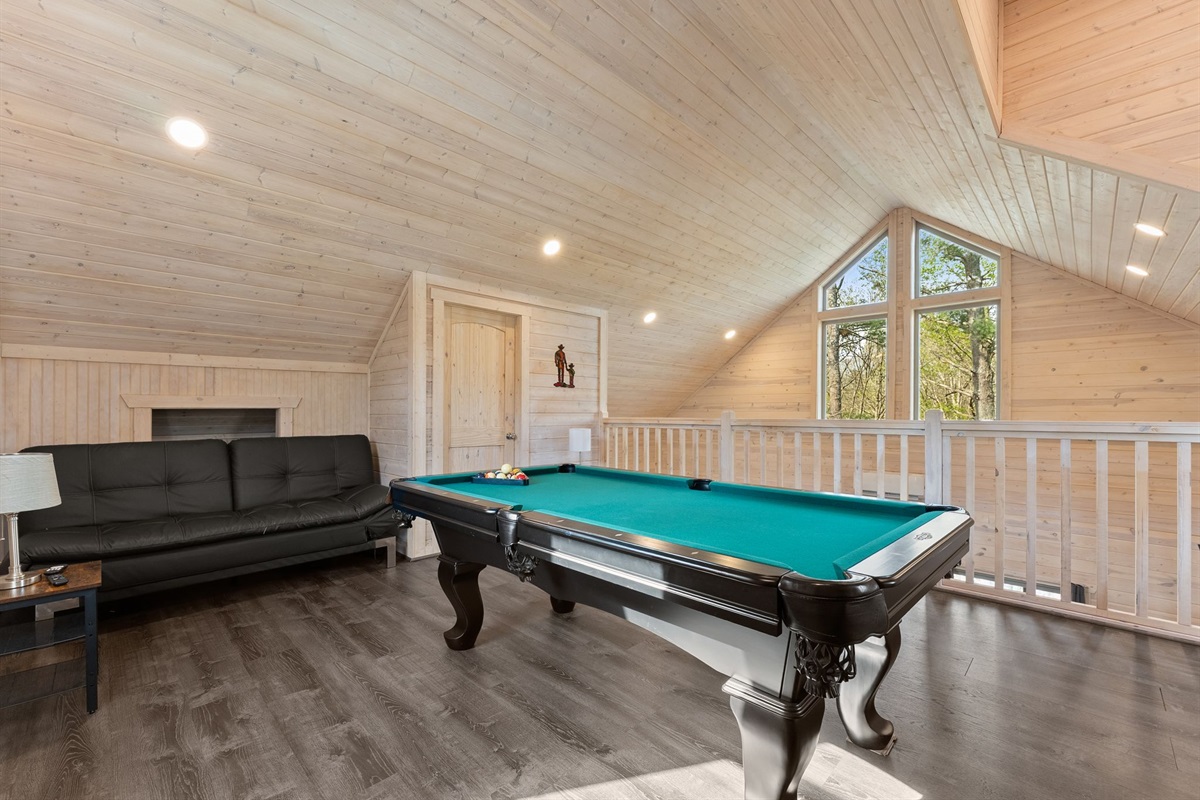 Slate Pool Table with Cozy Futon Seating for Fun and Relaxation
