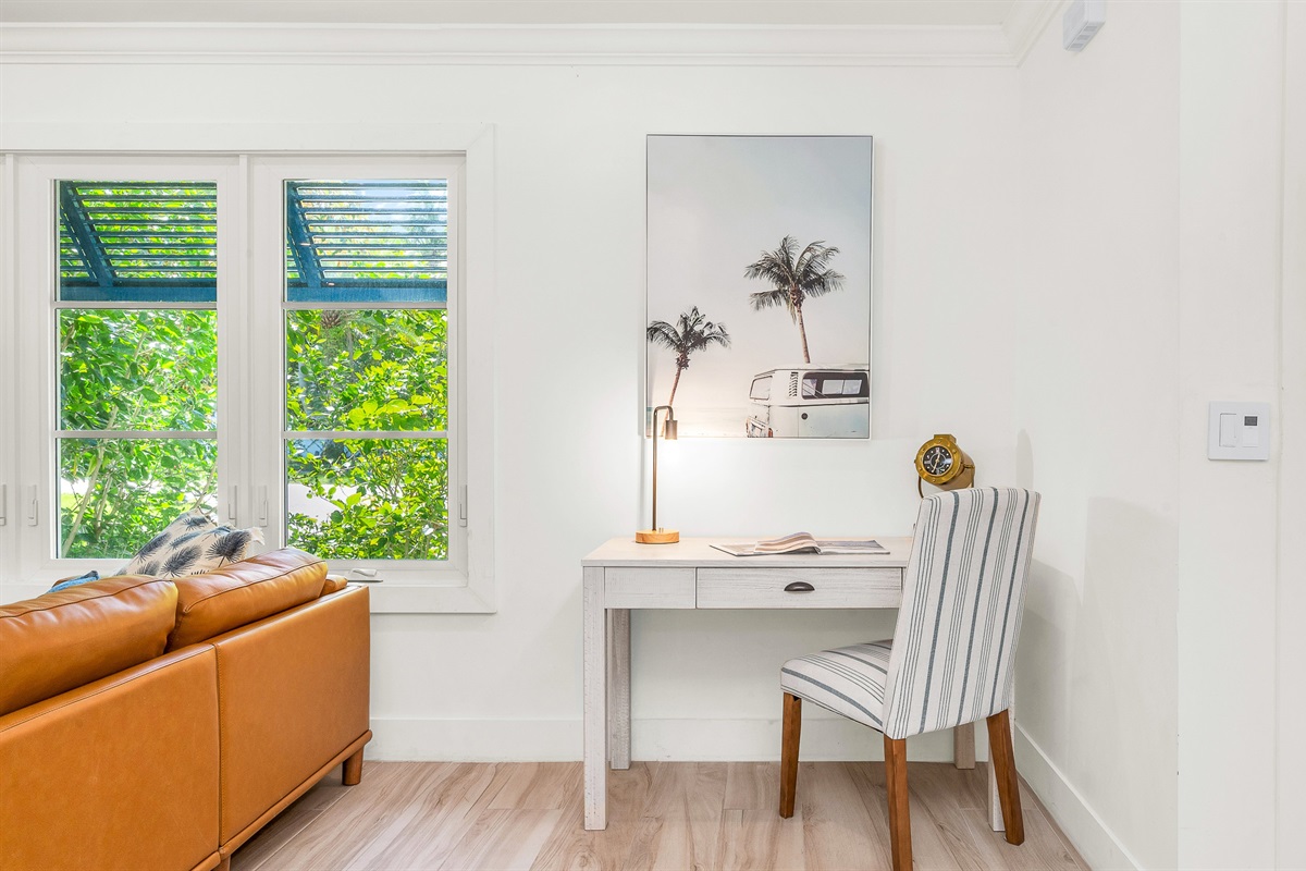 This bright and stylish workspace featuring a sleek modern desk and nautical-inspired decor, offers the perfect spot to stay productive while away from home, blending functionality with relaxed luxury,