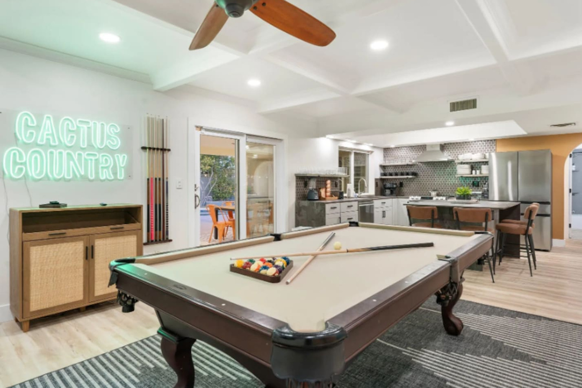The "Cactus Country" neon sign gives this game room its own personality, with a well-stocked kitchen never far from the action.

