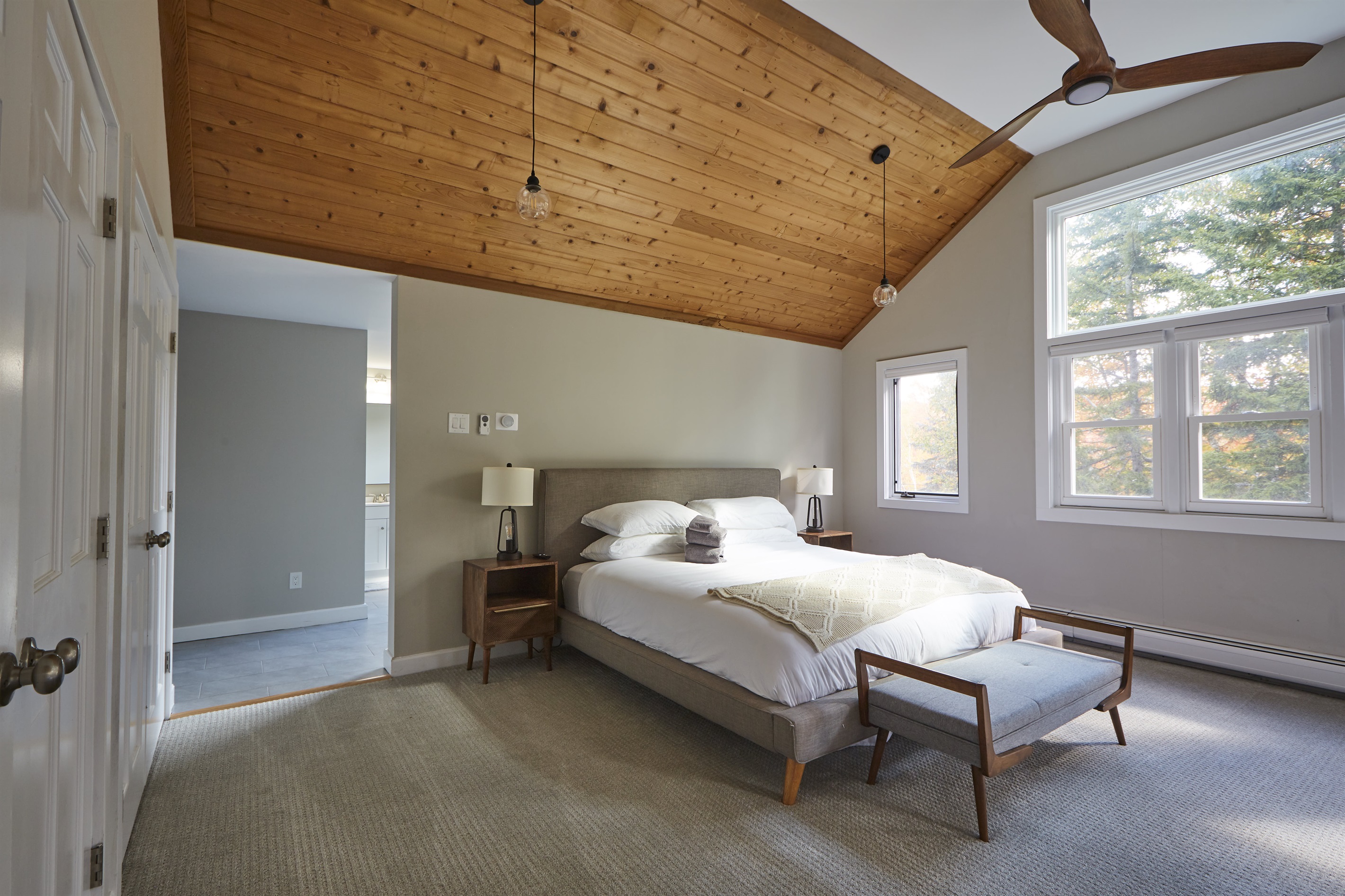 The master bedroom seamlessly flows into a large, recently renovated master bathroom.