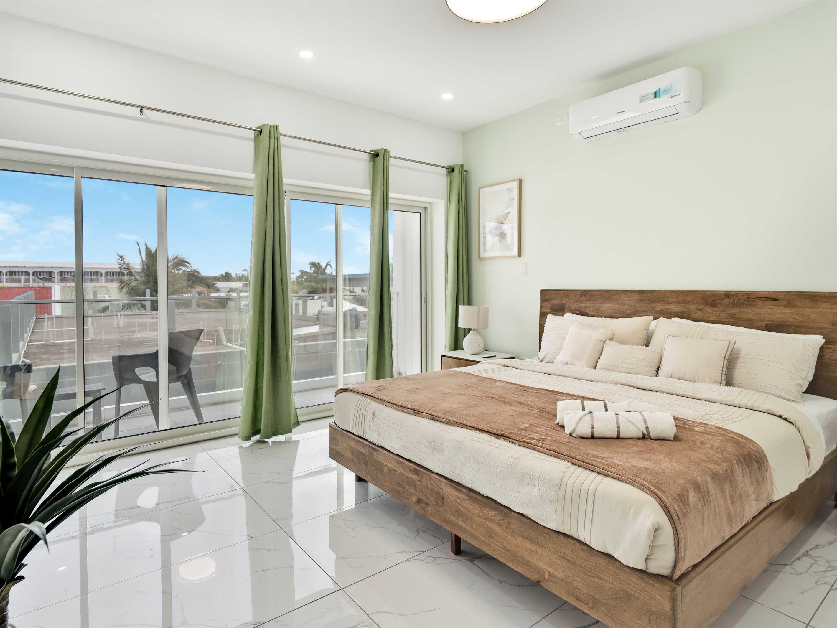 Sunlit King Bedroom with Neutral Tones & Balcony Access