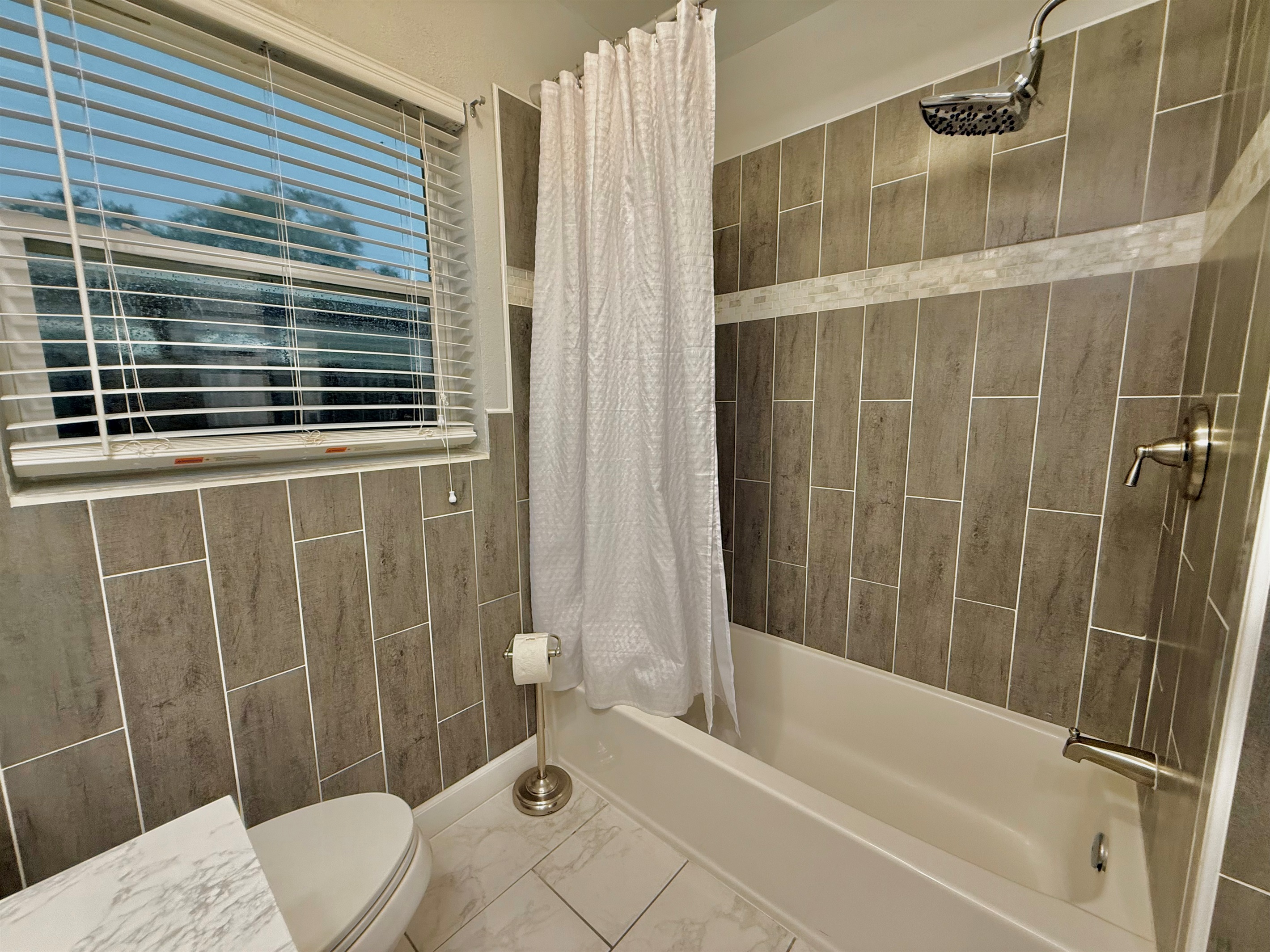 Start your day in a sparkling clean space with modern fixtures, soft lighting, and all the essentials waiting for you.