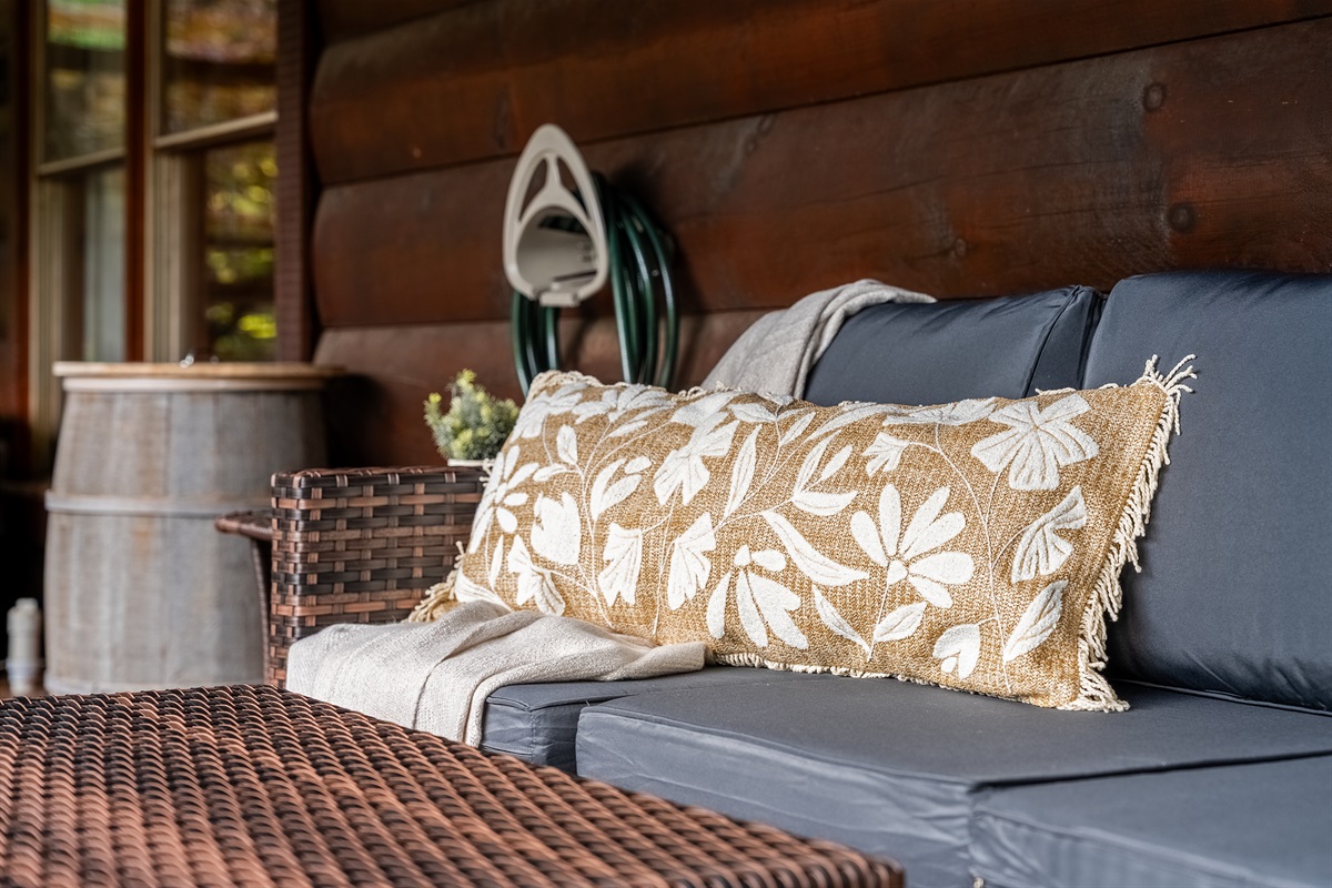 Relax on the covered deck’s cozy loveseat beside the hot tub. A comfortable spot to sip your morning coffee, unwind after a day of adventure, or enjoy the peaceful mountain atmosphere year-round.