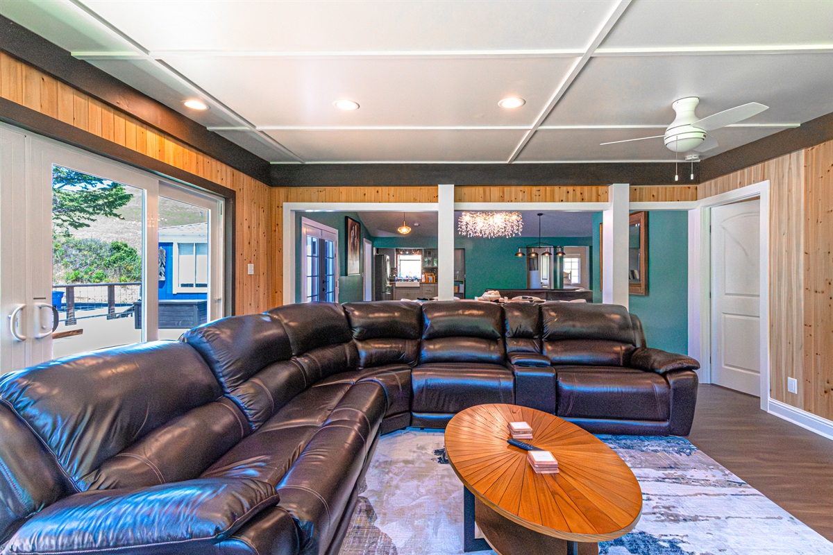 Framed by breathtaking waterfront scenery, the living room invites guests to unwind in sophisticated comfort after a day of adventure on the river.
