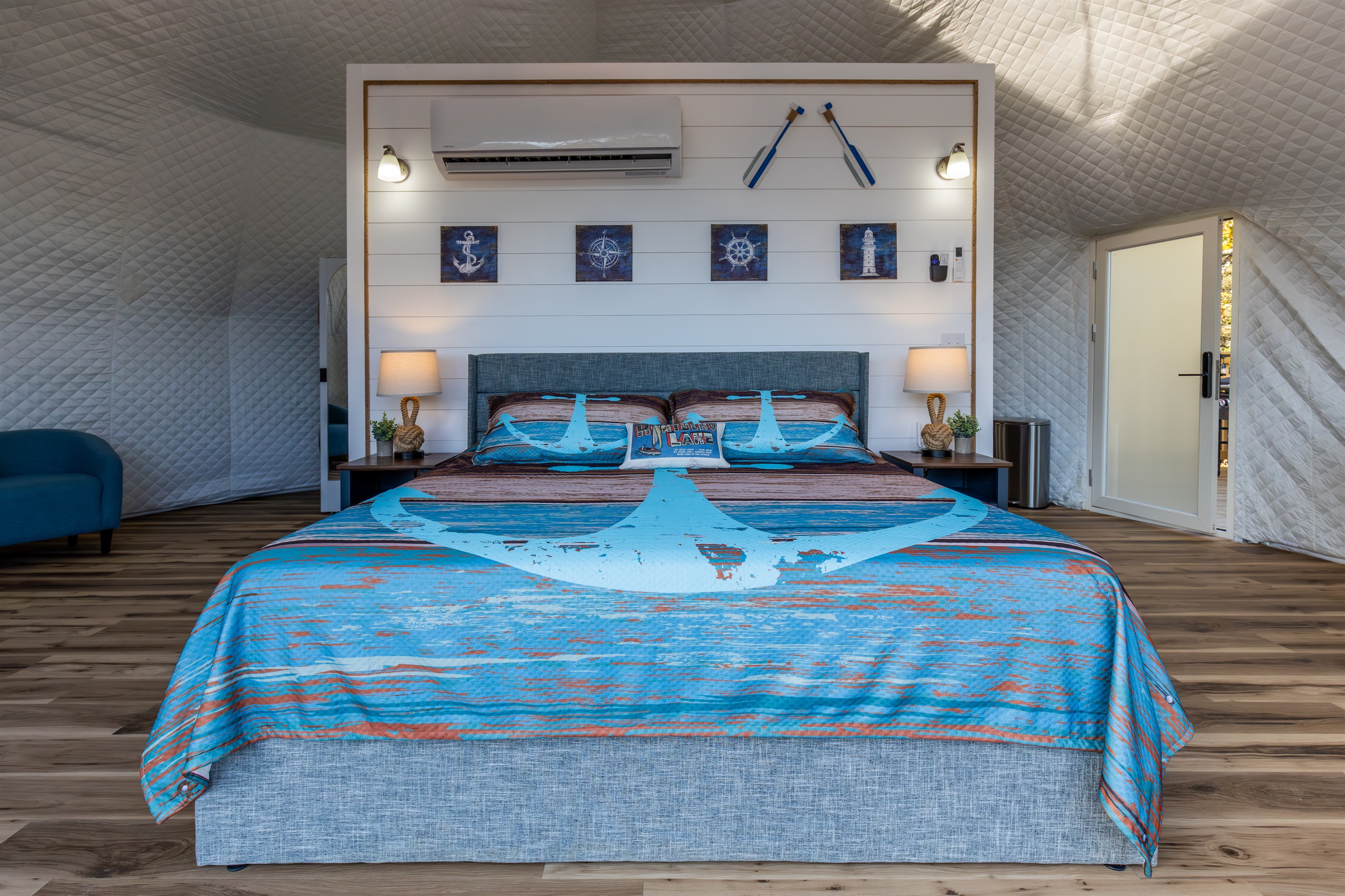 Wake up to panoramic lake views from this beautifully designed king bed inside your private Anchor-themed luxury dome