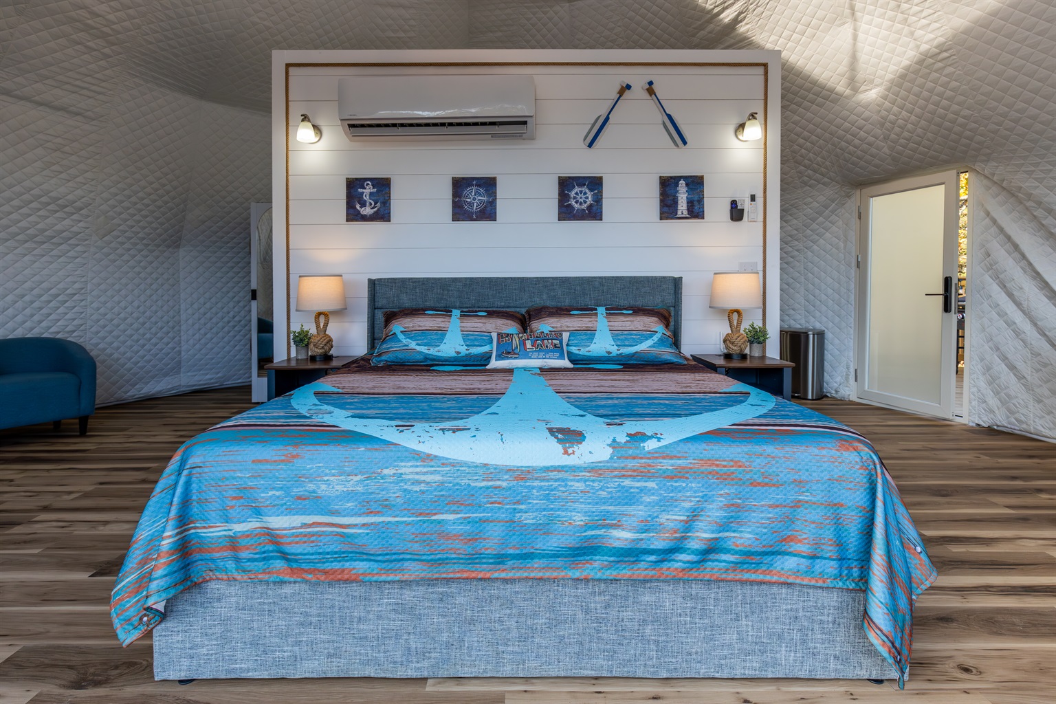 Wake up to panoramic lake views from this beautifully designed king bed inside your private Anchor-themed luxury dome