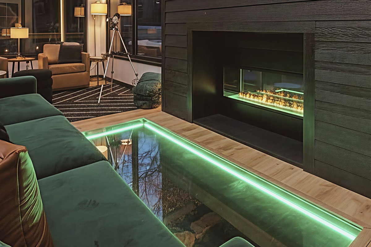 A glass floor reveals the creek flowing right below your feet—this is not your typical cabin stay