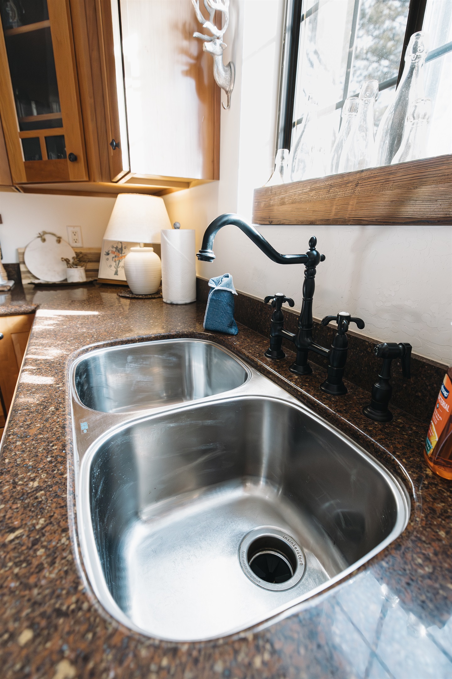 Bright, fully stocked kitchen with double sink, granite counters, and warm mountain touches—perfect for cooking meals together after lake days or ski adventures in Pinetop.