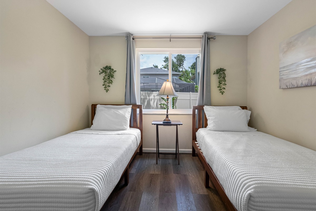 Perfect for guests seeking comfort, charm, and a bit of personal space, this thoughtfully designed bedroom features two cozy twin beds.
