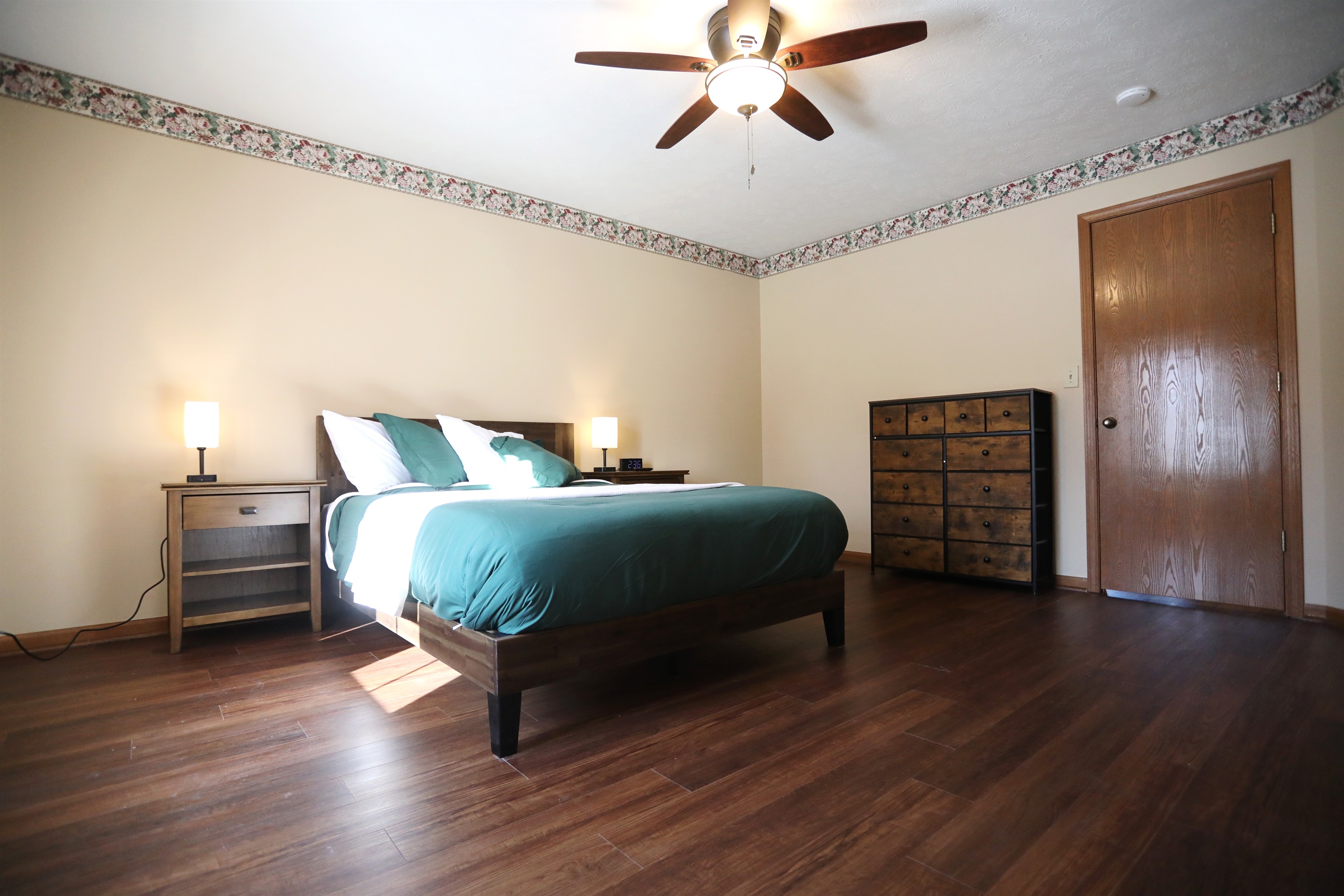 Master Suite showing dresser, queen size bed, nightstands with touch lamps and alarm clock