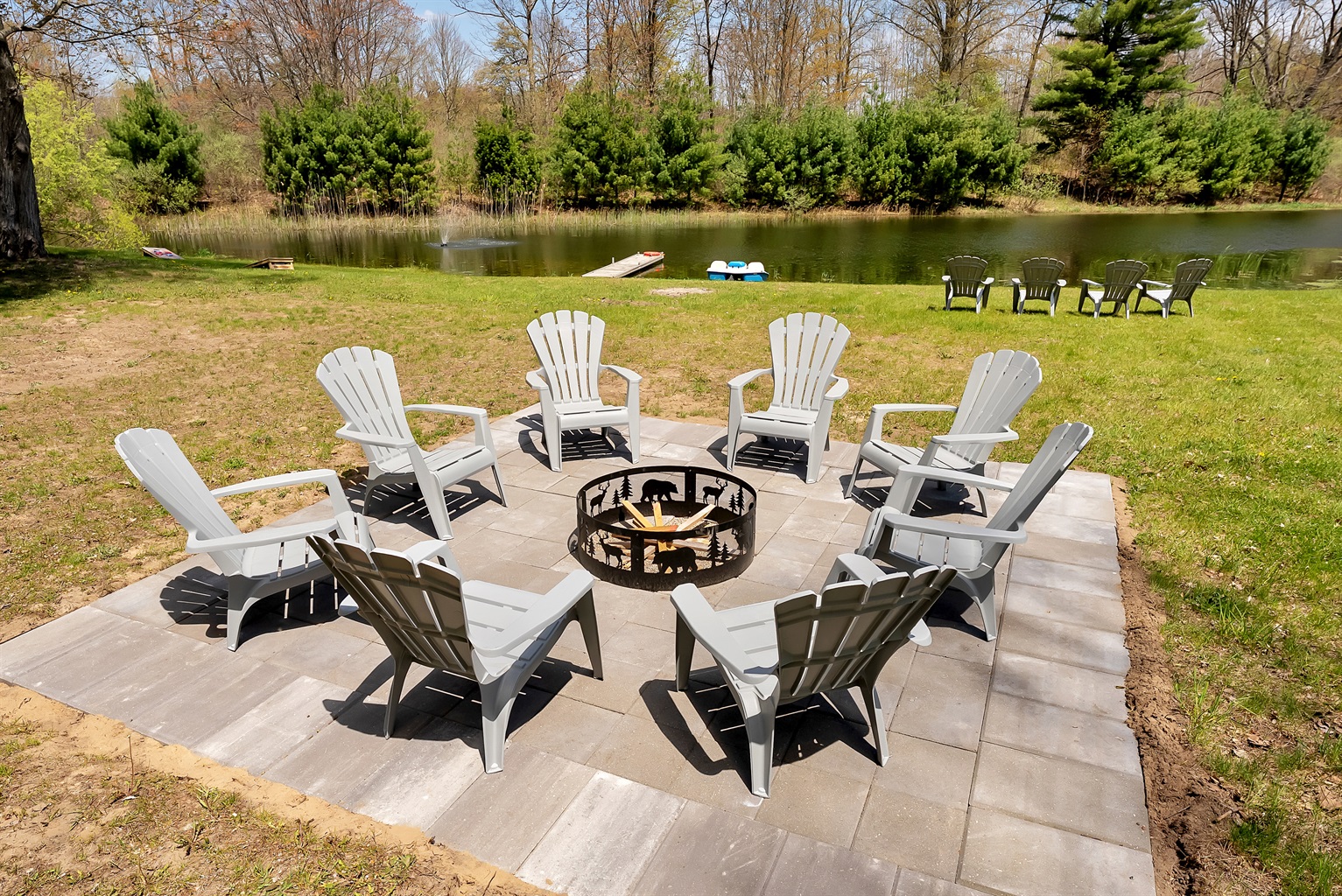 Fire pit with chairs overlooking our pond.