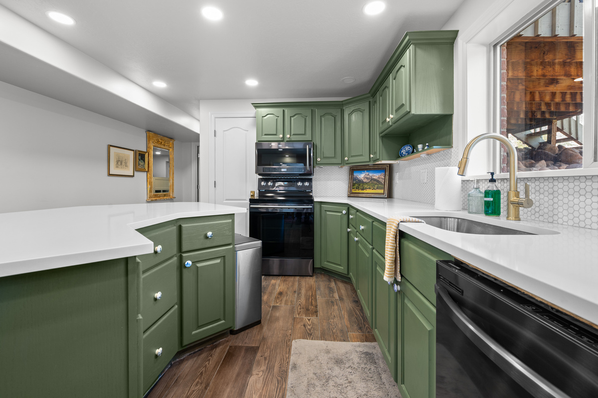 A substantial island, abundant cabinetry, modern appliances, and an open layout create an inviting space for preparing meals and gathering with family or friends.
