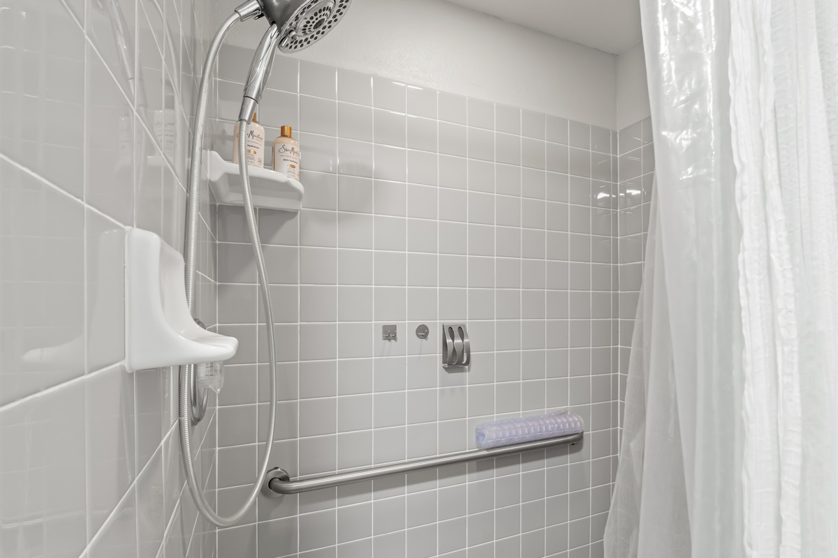Clean, modern walk-in shower with sleek tile surround, chrome fixtures, and spa-style handheld showerhead—simple, fresh, and designed for a relaxing start or end to your day.