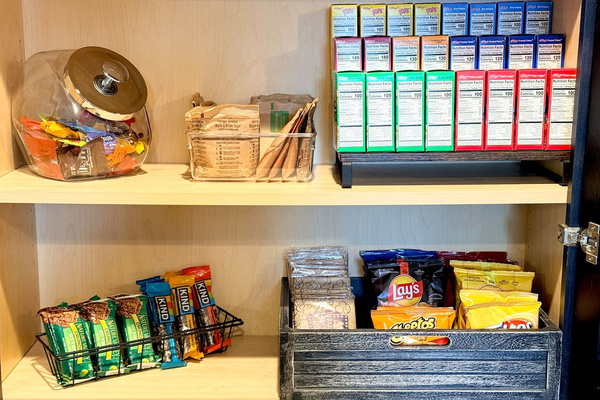 Pantry stocked with snacks, breakfast items, and convenient extras.