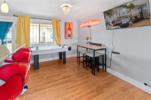 Witness a cinematic showdown with the action of a foosball table and the excitement unfolding on a 50-inch Roku TV, promising an evening filled with entertainment and friendly competition.