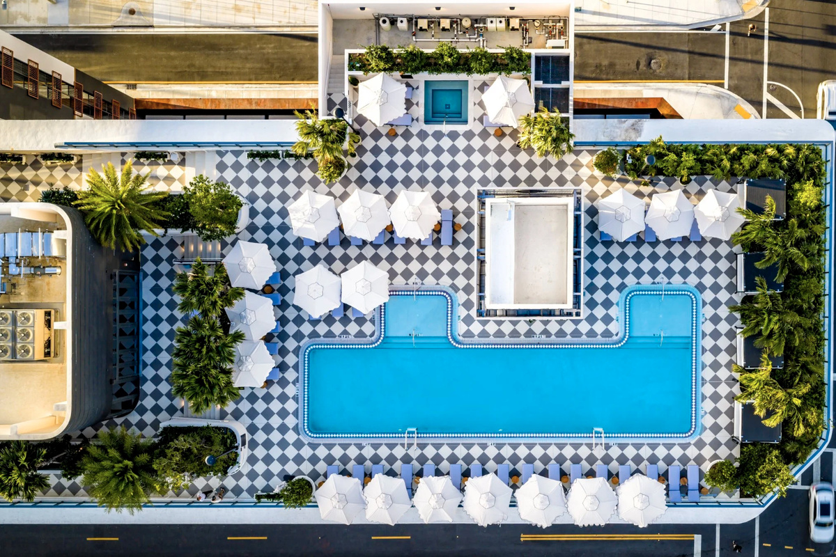 Aerial view of the rooftop pool deck - private cabanas and a sculpted waterline crowning the residences.