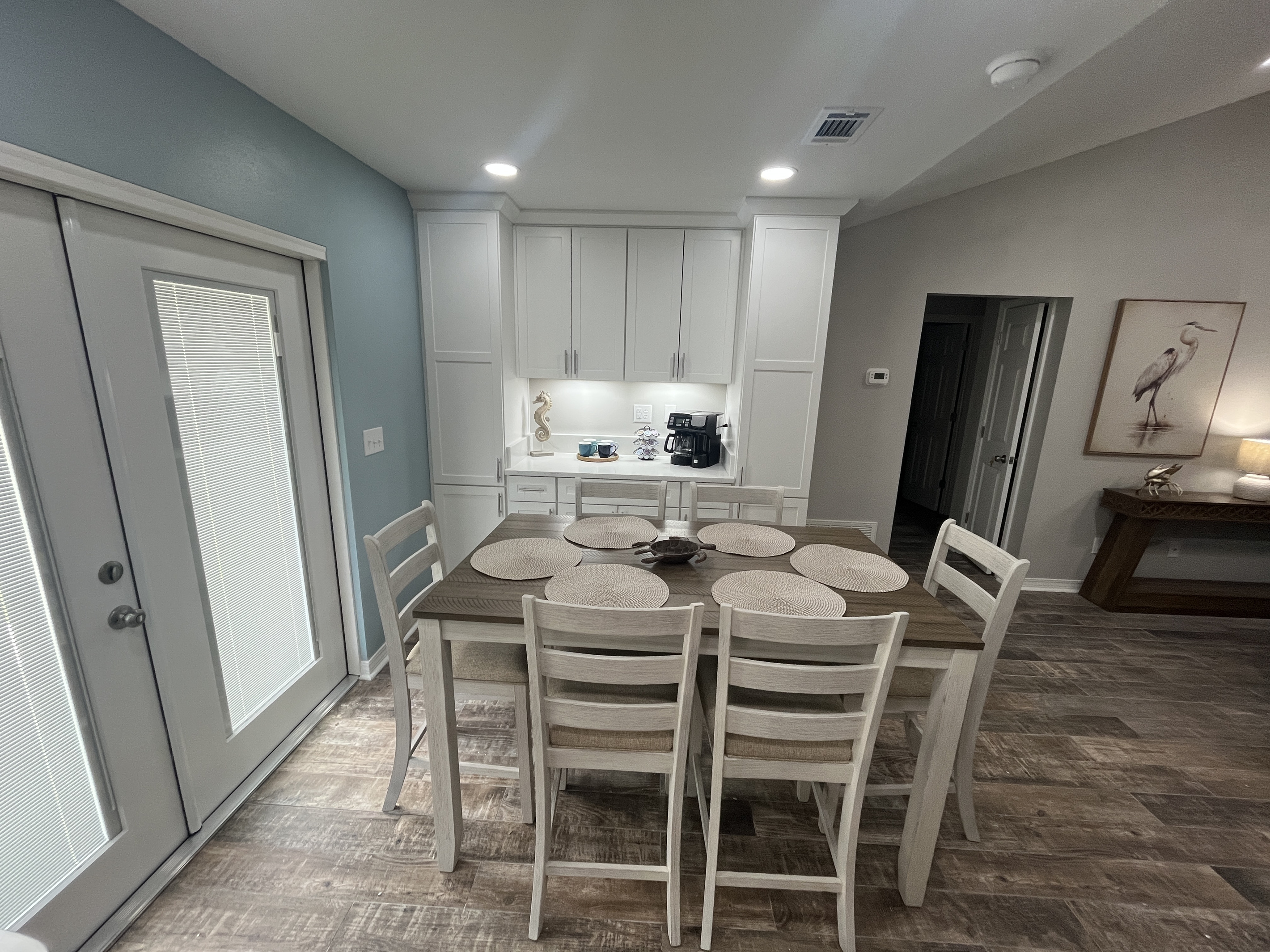 The high-top dining table seats 6.