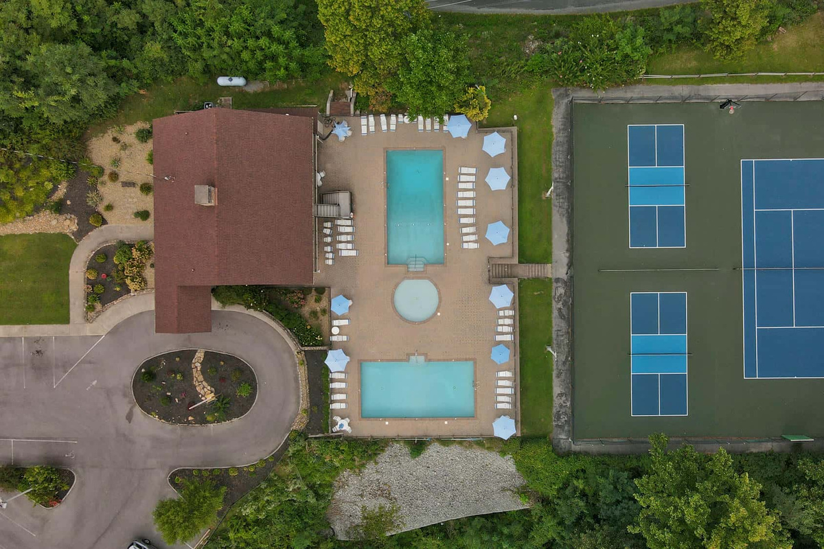 North Clubhouse with pools, pickleball courts, and tennis courts.