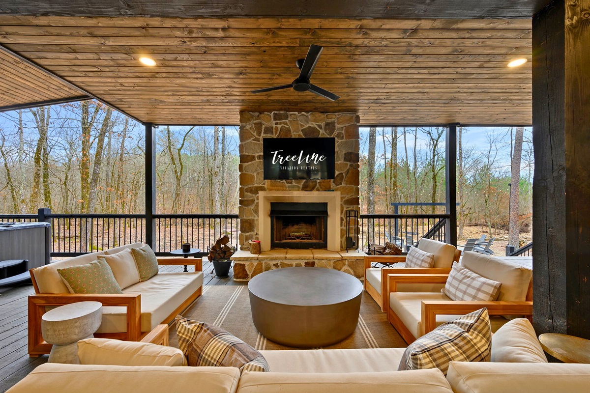 With comfortable chairs and a mounted TV, the outdoor living area invites you to settle in and enjoy the breeze.