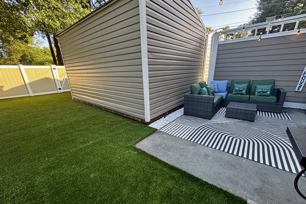 Low-maintenance private turf yard — room to play, lounge, and rinse off after the beach