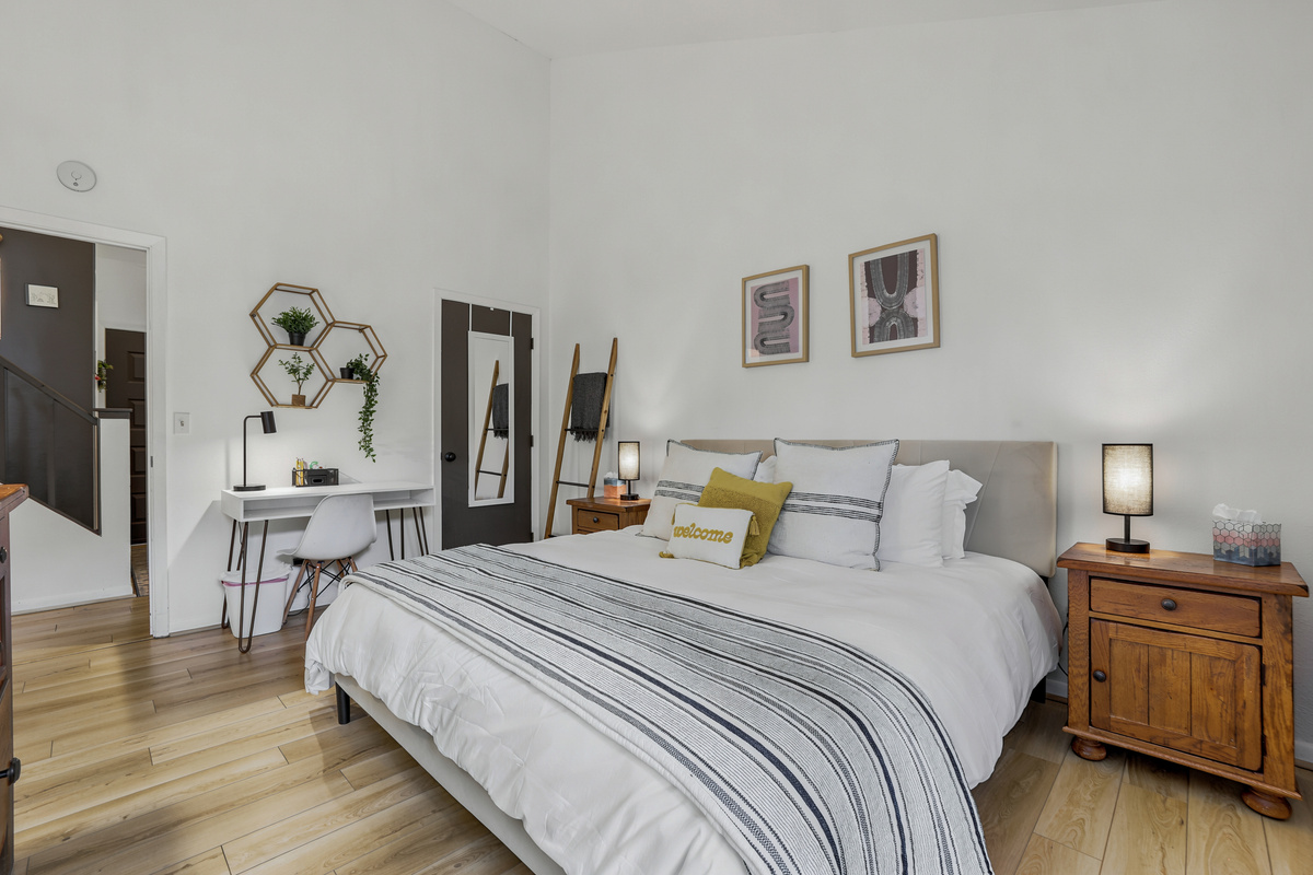 Bedroom 1, with 1 king bed and wall mounted TV