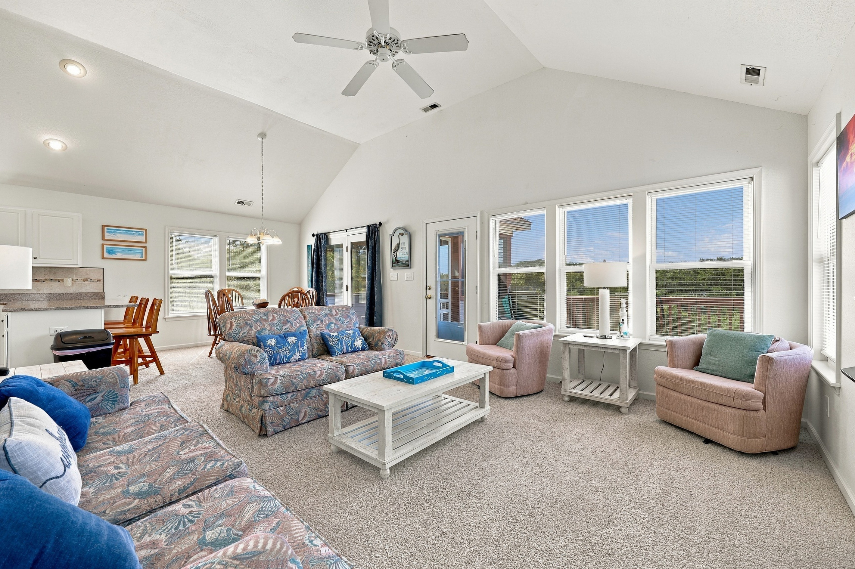 Kick back under vaulted ceilings in the sun-soaked great room, with comfy seating for the whole crew and a wall of windows.