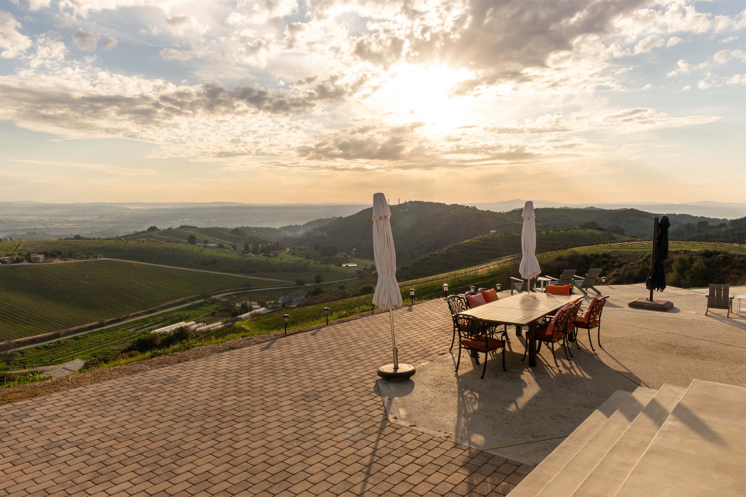 The sun breaks through the clouds over the Paso Robles valley in a final act that no one planned but everyone will remember. This is what evenings look like at the top of the hill.