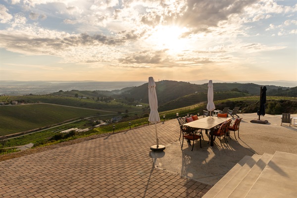 The sun breaks through the clouds over the Paso Robles valley in a final act that no one planned but everyone will remember. This is what evenings look like at the top of the hill.
