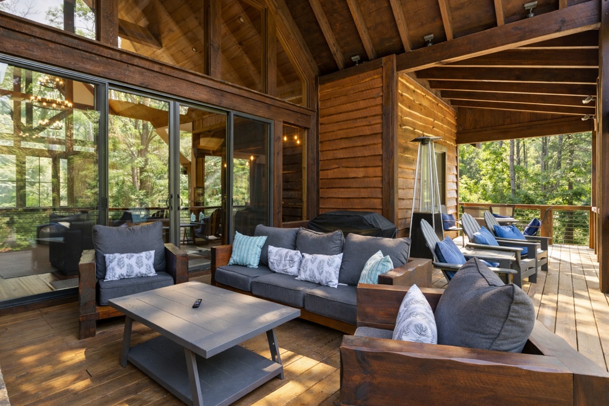 The spacious deck offers seating, a TV, and a cozy fireplace, making it a favorite spot to relax year-round.