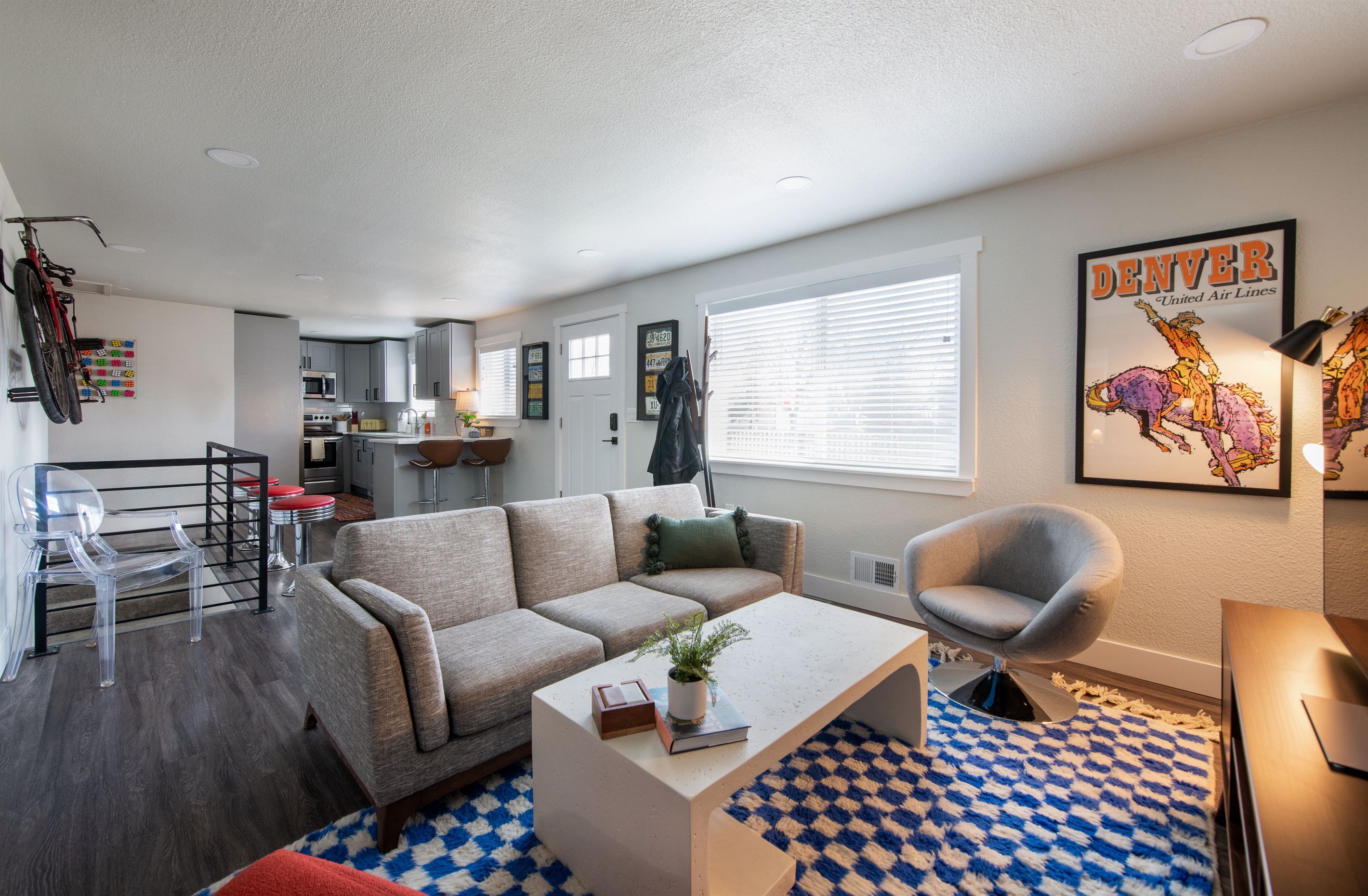 Large open entrance area and living room, and an all time classic United Airlines Denver poster from a while back...