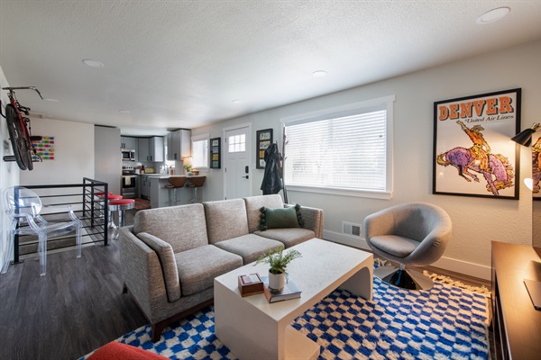 Large open entrance area and living room, and an all time classic United Airlines Denver poster from a while back...