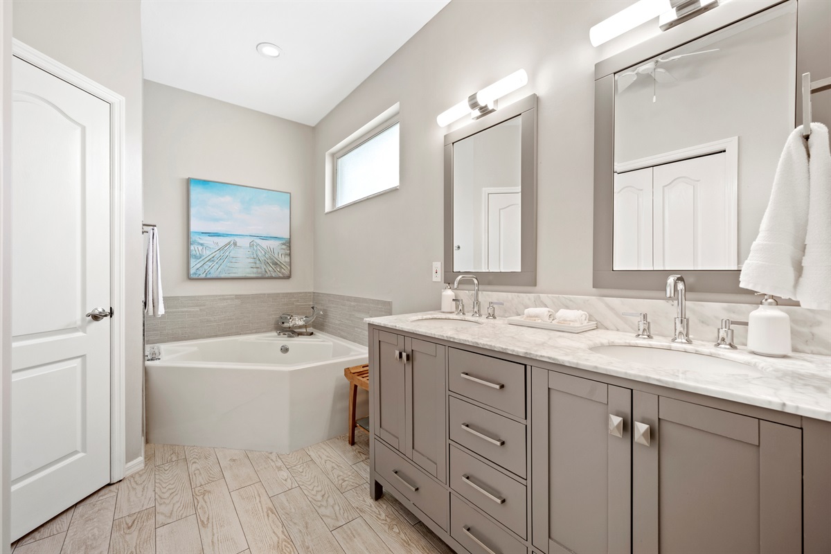 Newly renovated master ensuite with marble counters, dual vanities, and a deep soaker tub