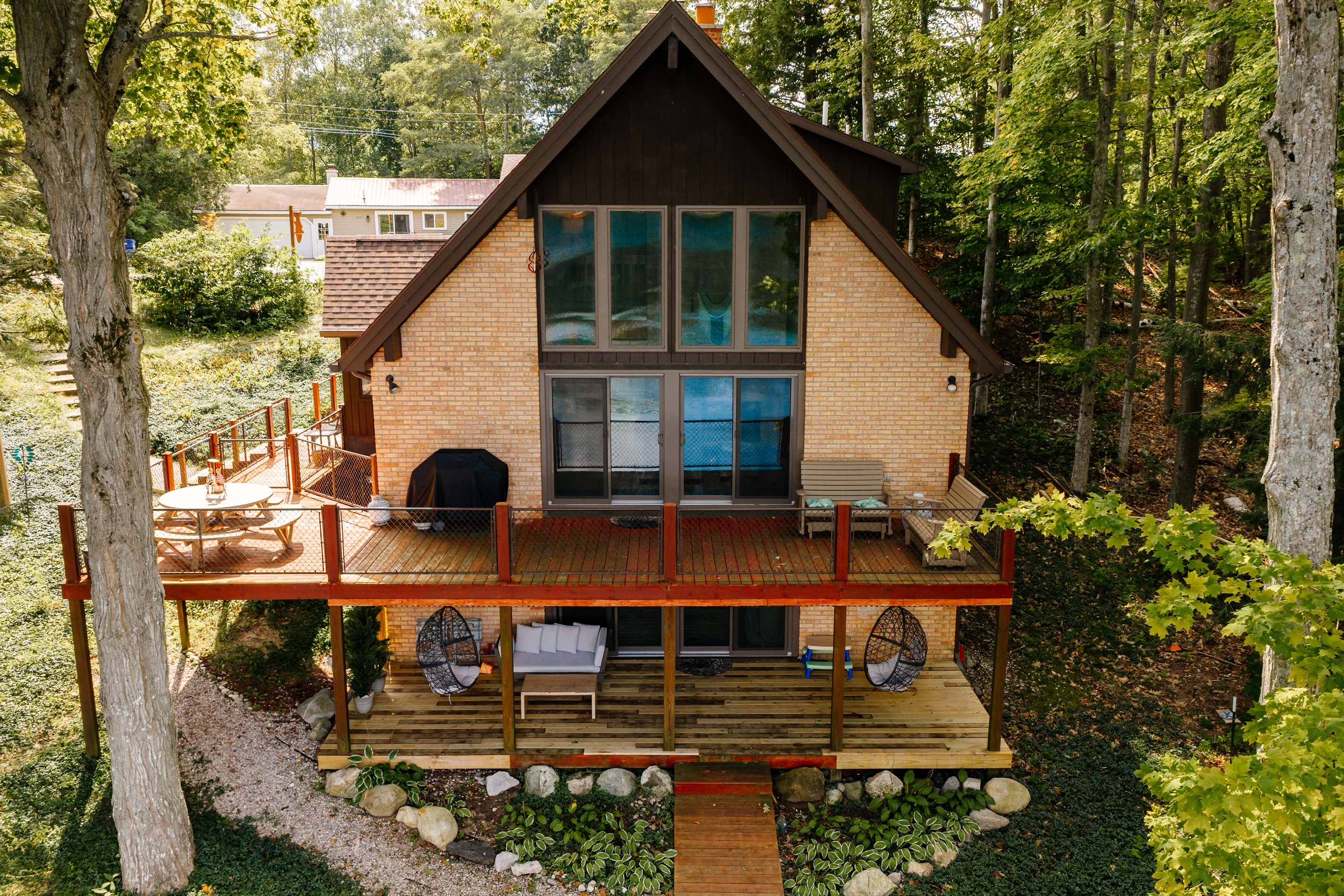Front view of the lakehouse with spacious deck and grill