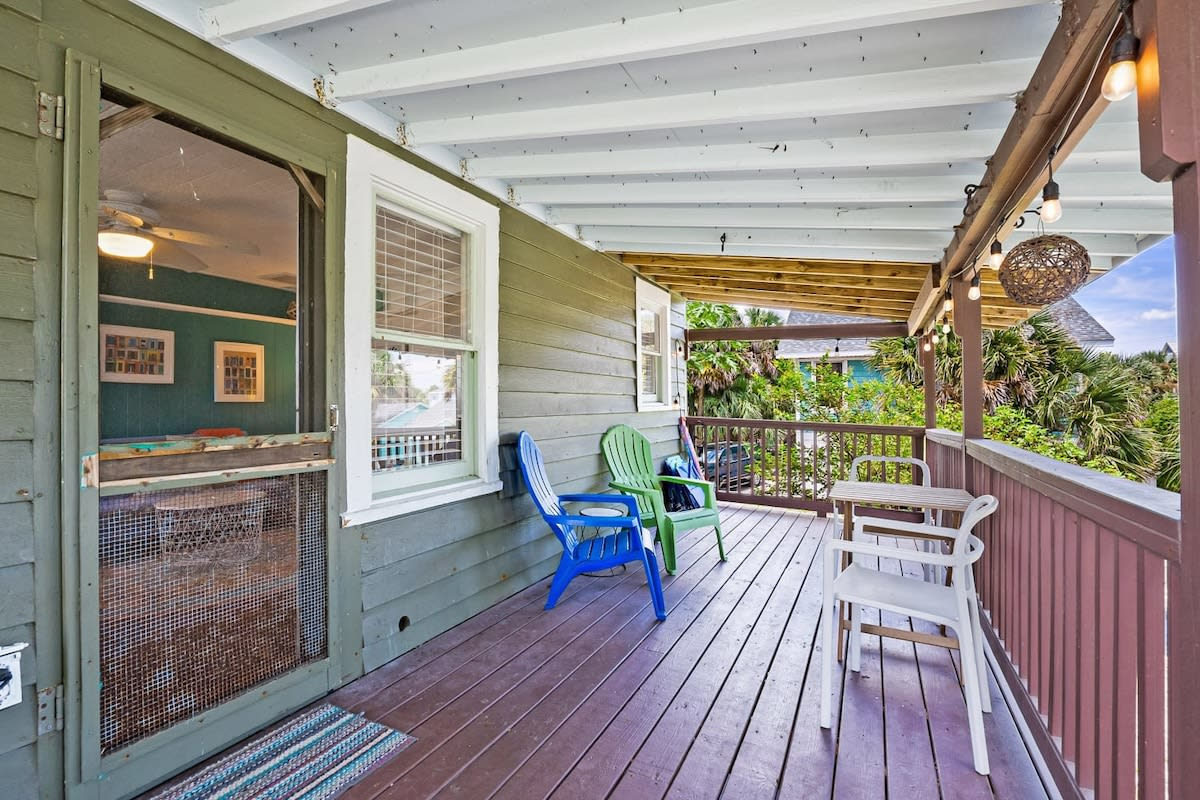 The covered balcony is easily the coolest spot on the property when the afternoon turns fierce. Shade, a breeze coming through the screens, and a chair with your name on it for just as long as you care to sit there.