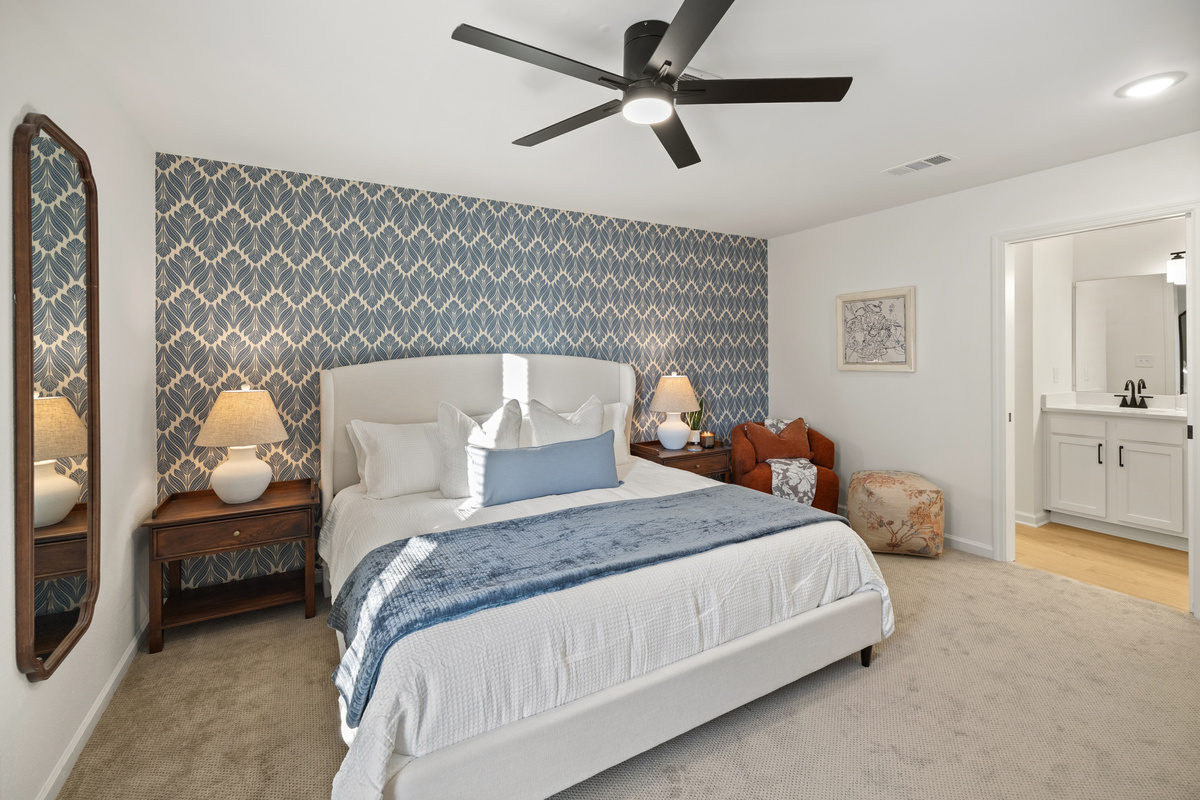The Navy Suite: a king bed, a quiet corner chair, and your own bath right through the door.