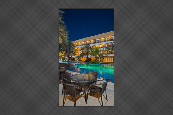 Relax by the illuminated pool. Perfect for a peaceful evening outdoors.