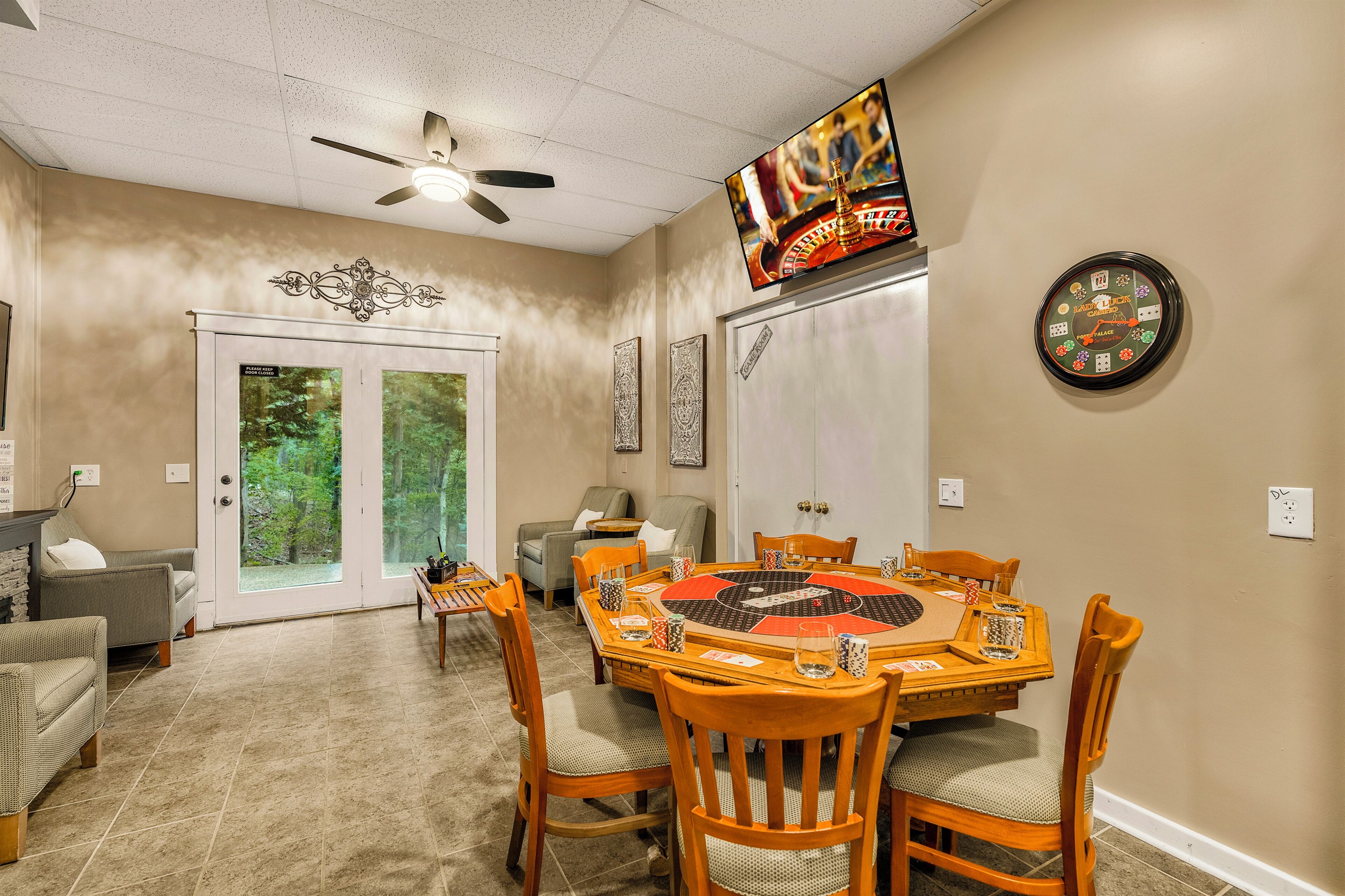 Lounge area with card table and TV with Xbox Series S
