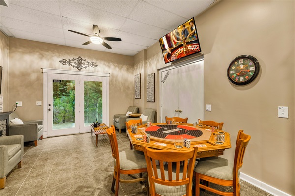 Lounge area with card table and TV with Xbox Series S
